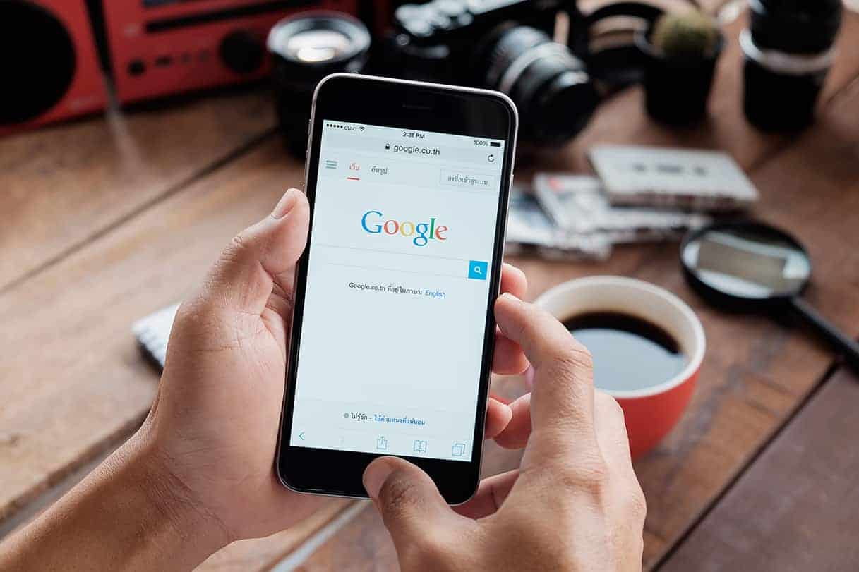 man holding a phone with google showing on screen
